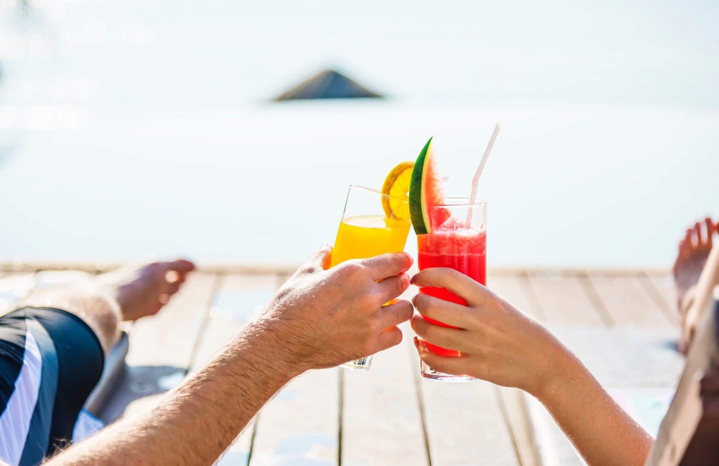 Hands holding some cocktails.